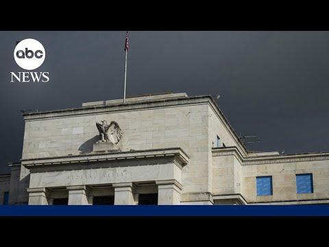Fed holds interest rates steady, defying Trump