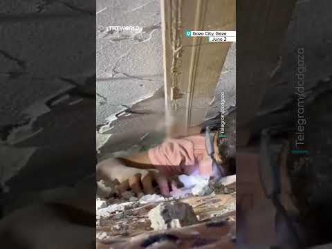 Palestine Civil Defence crew rescue child and infant from under the rubble