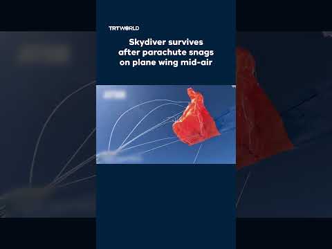 Skydiver’s parachute snags on plane wing mid-air