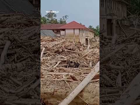 Massive piles of timber and rubble cover Aceh mosque