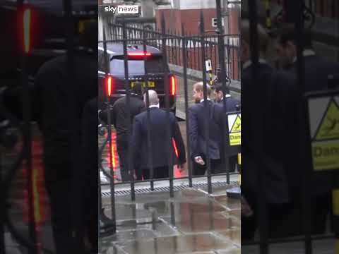 Prince Harry smiles leaving court