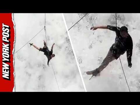 Tourist Left Dangling From Rope as Waterfall Continuously Crashes Over Him