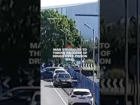 Man struggles to throw package of drugs over prison wall