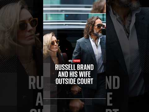 Russell Brand and his wife outside court
